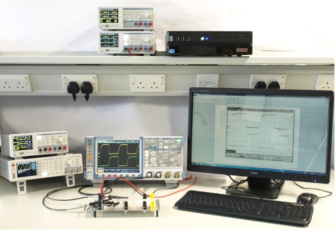 A photograph of one of the workstations located in Engineering East B107 Electronics Teaching Laboratory showing PC, the laboratory instruments and connections to a prototype circuit board.