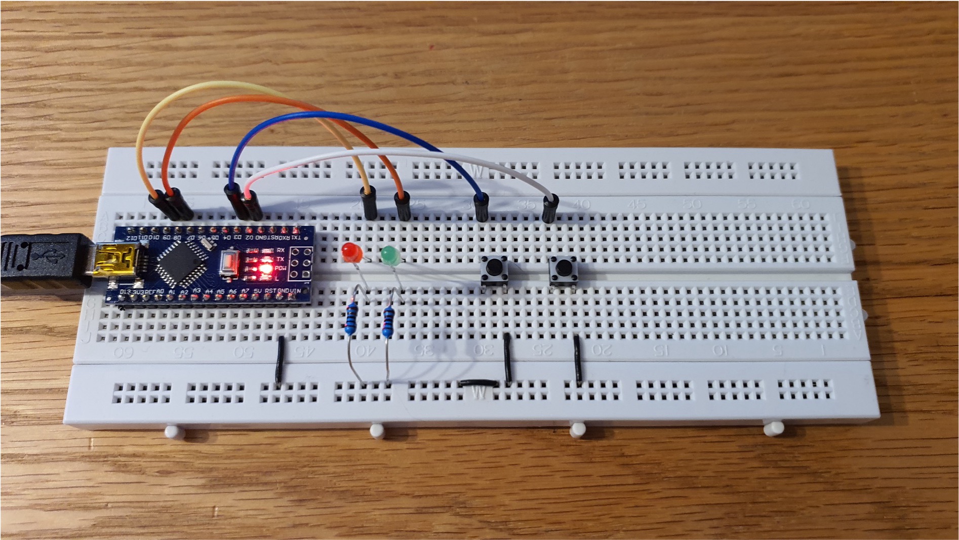 A photograph of the example circuit which has two buttons and two LEDs.